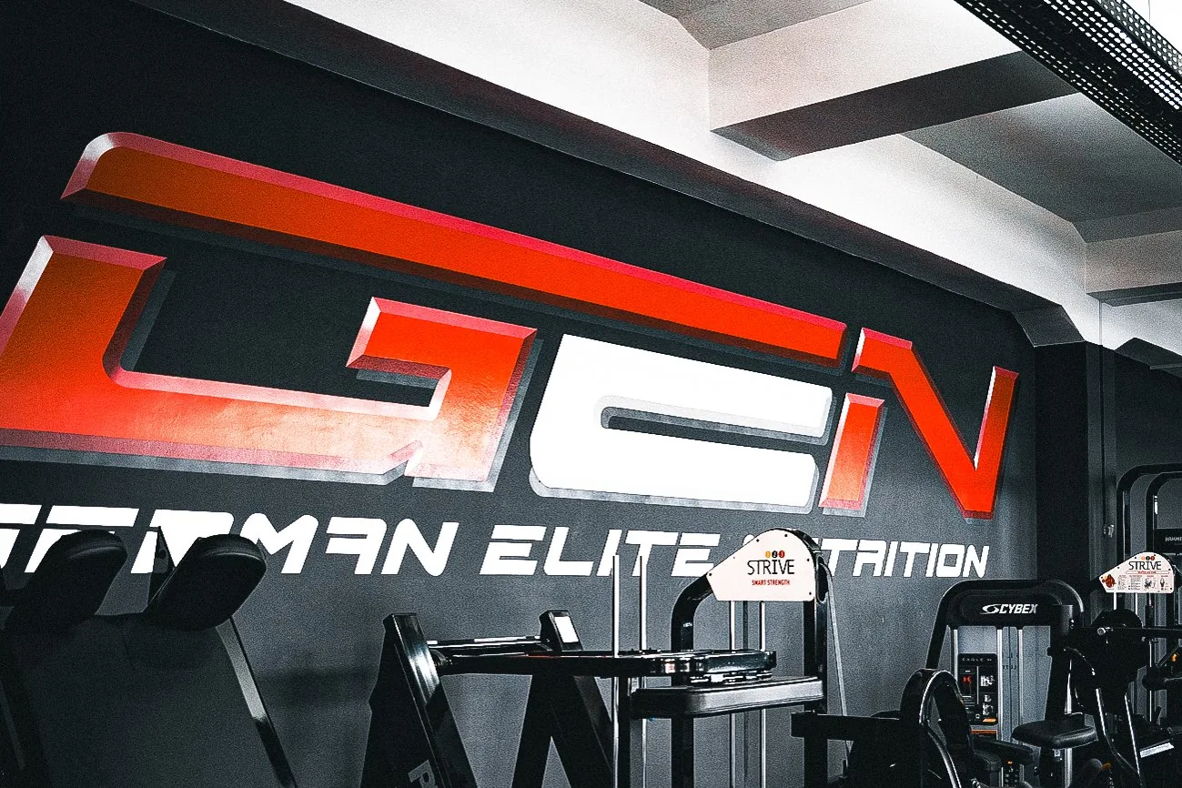 Große GEN German Elite Nutrition Wandbeschriftung über der Trainingsfläche im Invictus Gym Hamburg